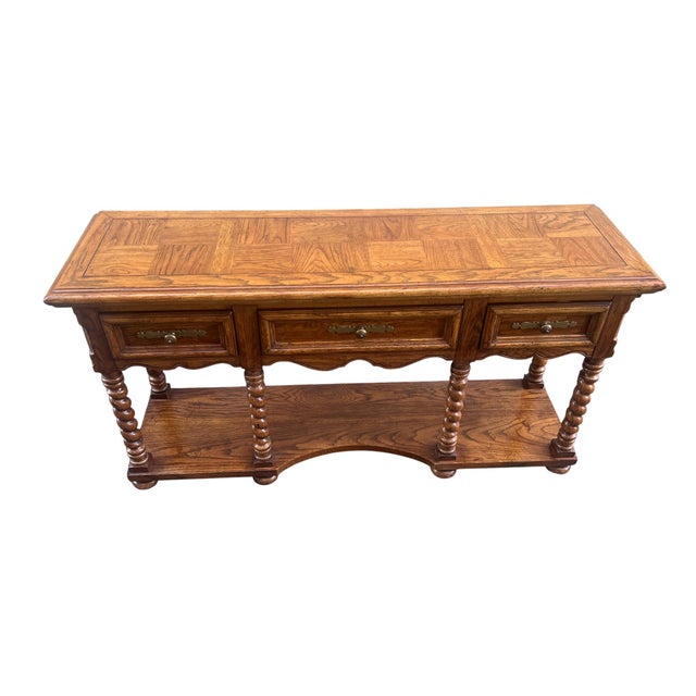Nice style oak console table with brass drawer pulls and barley twist supports. Dovetailed drawers and middle drawer has...