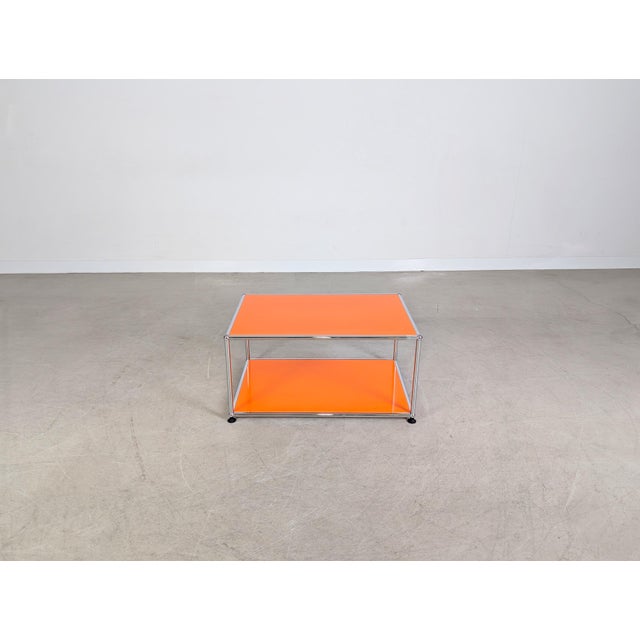 Beautiful coffee table from the renowned Swiss manufacturer USM Haller for sale. The table, featuring vibrant orange metal...
