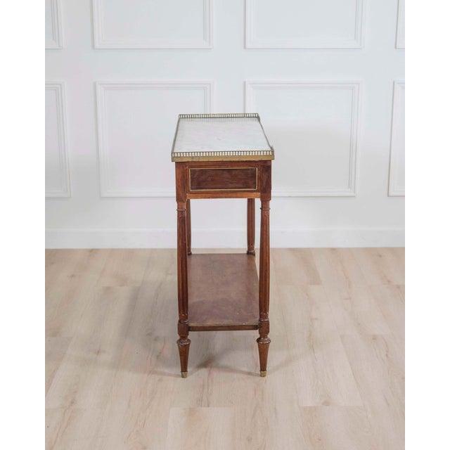 A refined early 19th century Louis XVI style console table, beautifully crafted in wood veneer with elegant neoclassical...