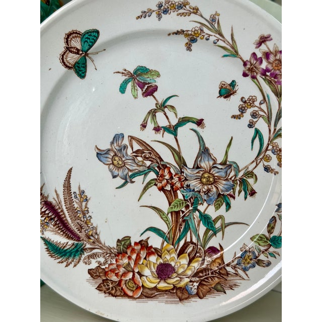Antique Aesthetic Movement ironstone plate featuring hand-colored flora and fauna transferware decoration. Detailed...