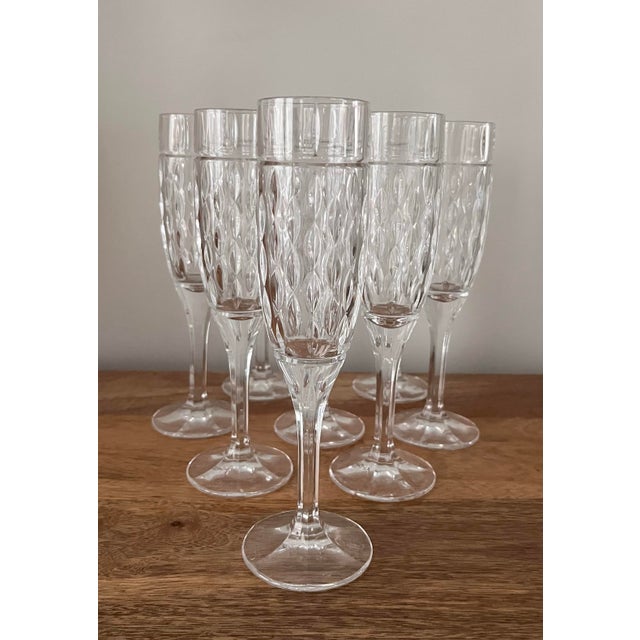 Gorgeous crystal flutes with a vertical cut petal pattern. This set of 8 stems was found at an estate sale outside of...