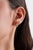 These elegant huggie hoop earrings feature a 0.36 ct natural oval-cut emerald, set in 14k yellow gold. accented by a...