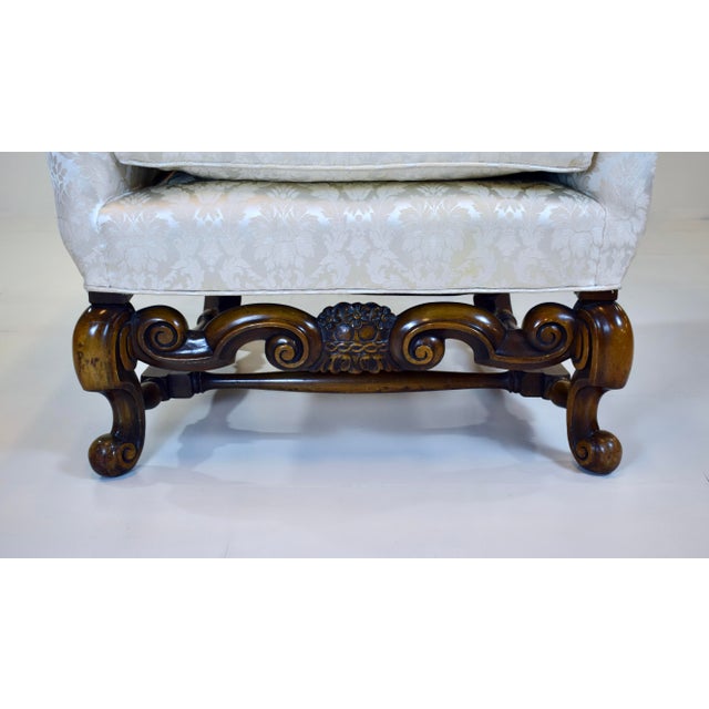 A stately Wing Chair by William Switzer, Pollack Collection, featuring scalloped back, intricate turned Cabriole carved...