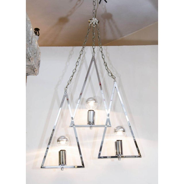 Mid-Century Modern Chrome Three-Light Chandelier, mid 20th century, of triple triangle form pendant on chains. 9" H x 8" W...