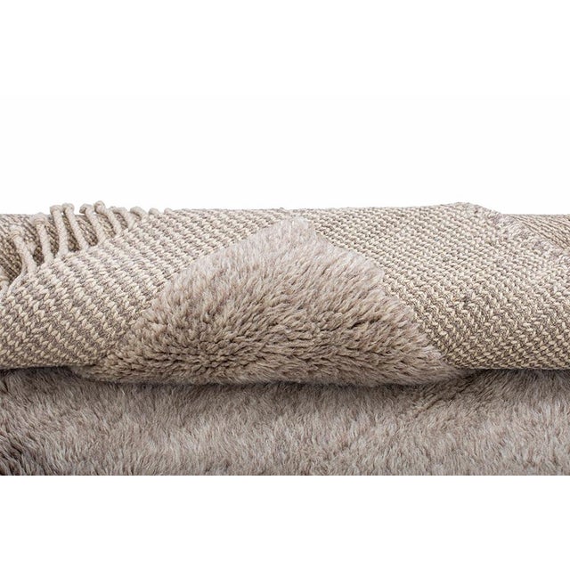 Quiet texture, softly imperfect edges. This hand-knotted Moroccan wool rug embraces subtle tonal variation, pairing desert...