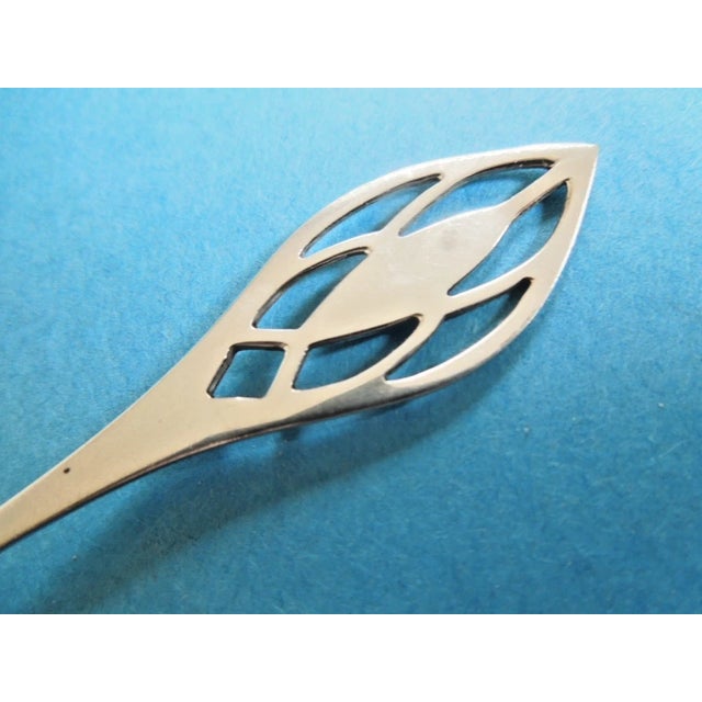 An elegant sterling silver 3 tine lemon fork Marked "Sterling" with Baker Manchester hallmark Handle has Pierced Handle...