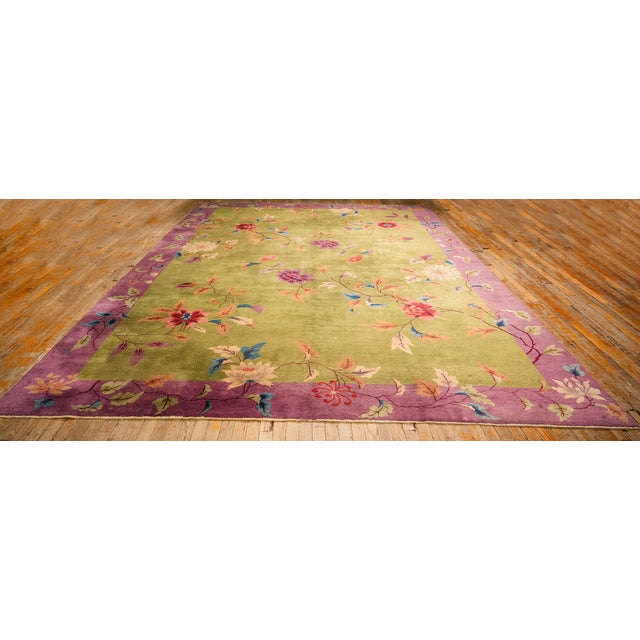 A grand room-sized Antique Chinese Art Deco carpet, circa 1920. Measuring 9' 9" x 13' 5", this exceptional piece features...