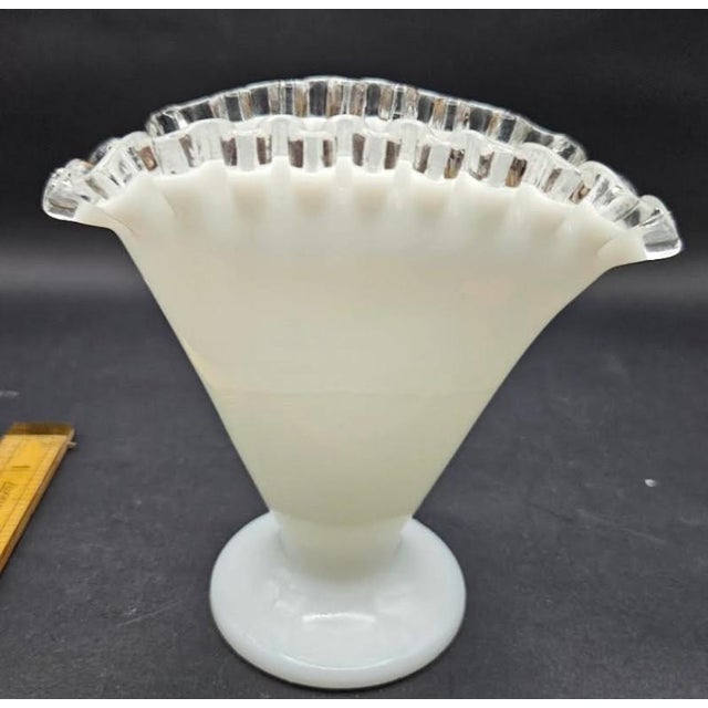This marvelous unmarked Fenton vase is created in gorgoeus milk glass with a clear crimp crest on the top edges. This...