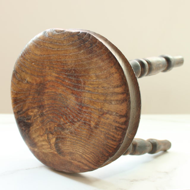 19th Century Petite English hand carved footstool with time worn distressing throughout. Made of solid hardwood. We...