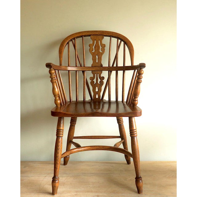 Solid oak lyre-back Windsor chair with a horse-shoe shaped arm bow, 1960s. Beautiful colour and wood grain. Two chairs...