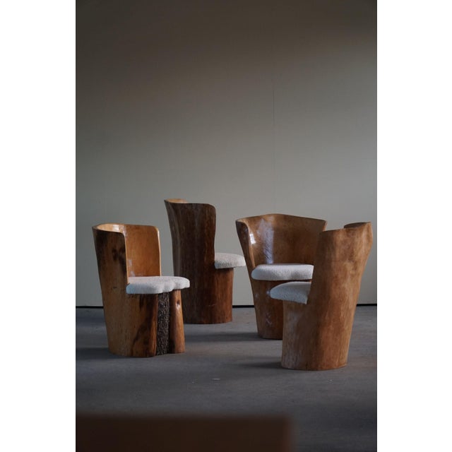 A truly unique dining set of 4 stump chairs, made in solid pine and reupholstered in bouclé wool. Hand carved in Sweden by...