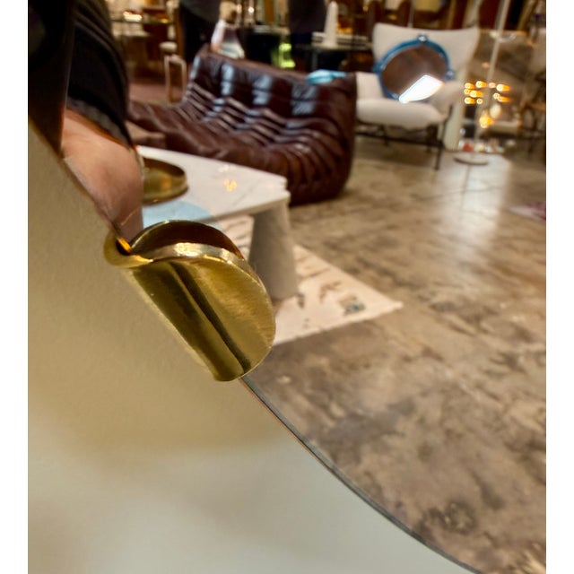 Vintage Italian convex mirror from the 1970s featuring an amber-tinted reflective surface. The domed form creates dramatic...