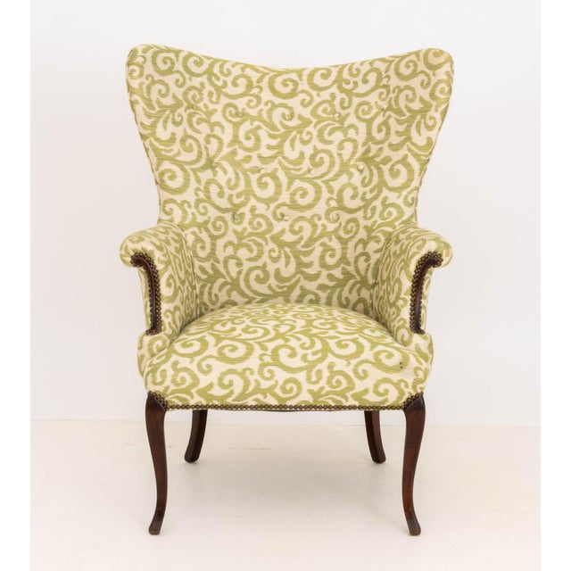 Chippendale Style Upholstered Wingback Arm Chair, with riveted trim and mahogany cabriole legs. 44.25" H &nbsp;x 32" W x...