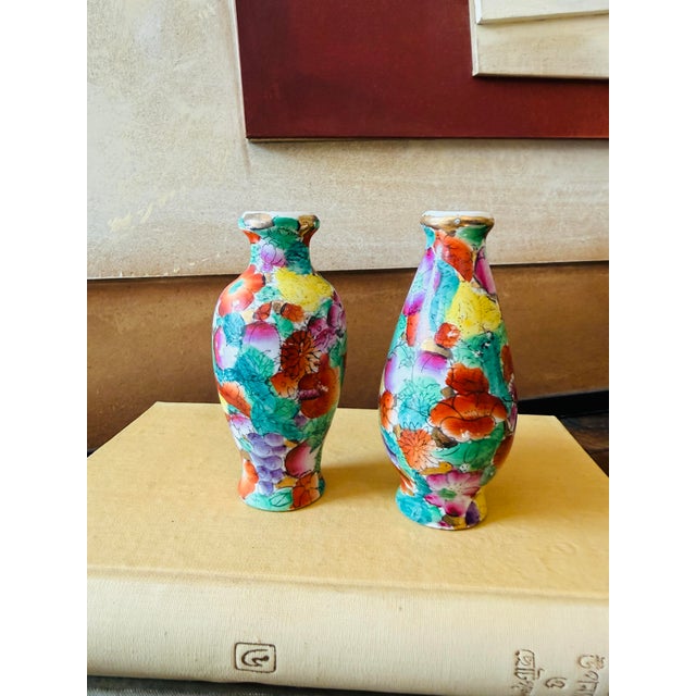 A beautiful pair of vintage miniature porcelain vases decorated in the exuberant Millefleurs, or “100 Flowers,” pattern....