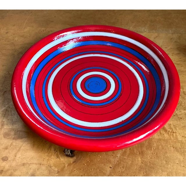 This vintage Raymor plate is a striking display of hand-applied concentric banding, with alternating rings of saturated...