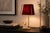 French decorative table lamp dating to the 1970s, with a gold-toned metal base and an offset slender lamp stem. Beside the...