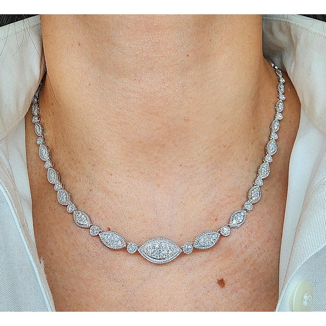 This stunning diamond necklace has 220 diamonds encased in 18k white gold. The diamonds boast a color of E/F and VS in...