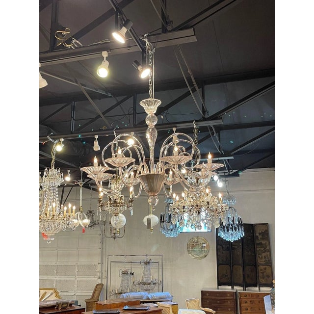 Stylish modern pink Murano glass chandelier with 8 lights. This fixture has a very unique and whimsical look with its...