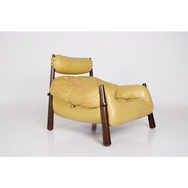 Presented in its most recognizable version, combining yellow leather and rosewood, the mp-81 armchair by percival lafer is...