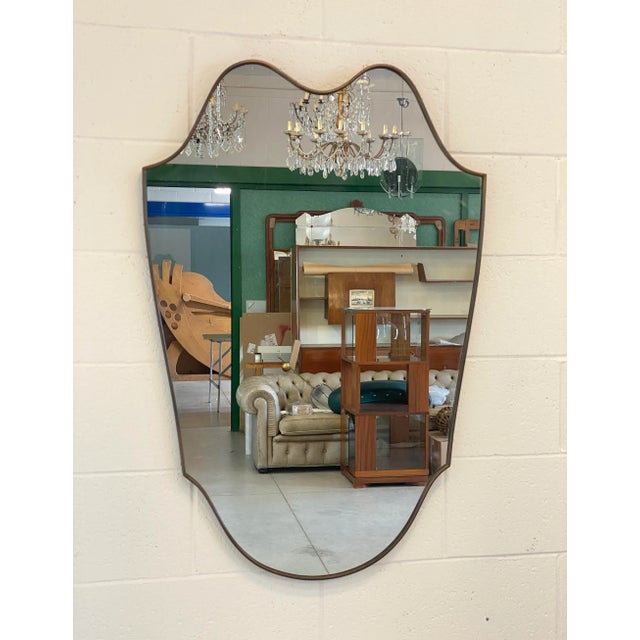 1950s shaped mirror, brass frame