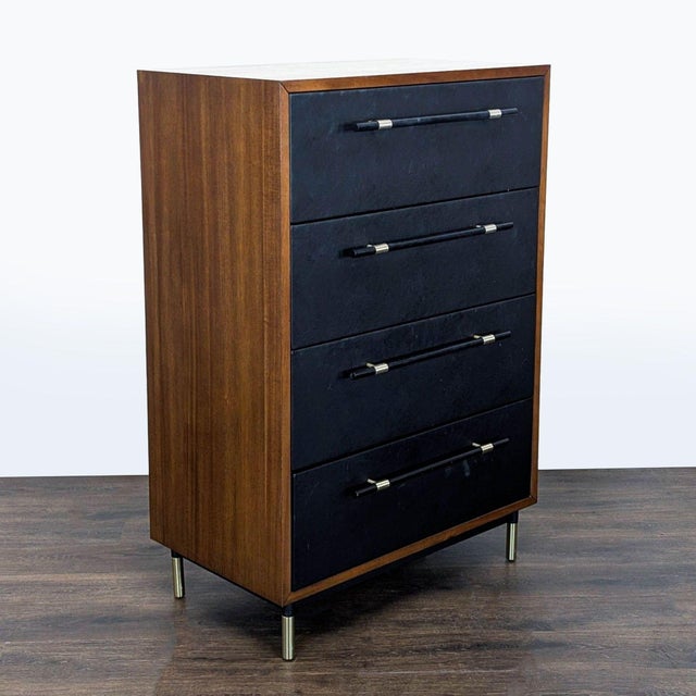 This CB2 dresser features a sleek modern design with four spacious drawers. The rich wood frame pairs with faux leather...
