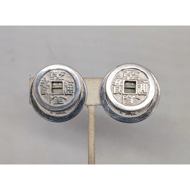 Napier Vintage Signed Napier Doris Day Rhodium Plated Two Stacked Asian Coins Clip Earrings-2 Pieces For Sale - Image 4 of 9