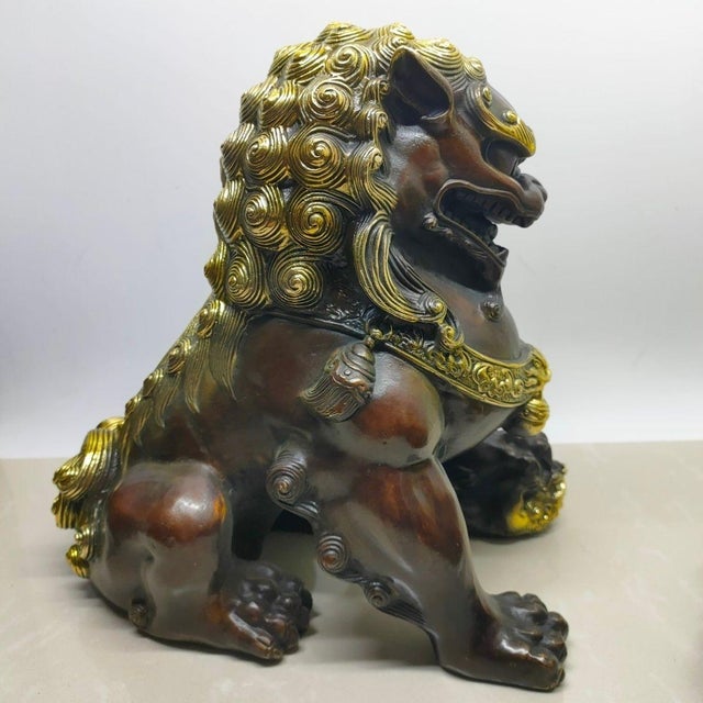 A fierce and majestic pair of vintage Chinese guardian lions (commonly known as Foo Dogs), sourced from a private...