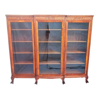 Antique 1890's Tiger Oak Lion / North Wind Carved 3-Door Bookcase With Claw Feet For Sale