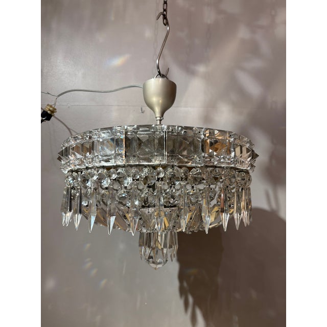 This elegant 1950s Italian flush-mount chandelier features a refined chromed-metal structure enriched with high-quality...