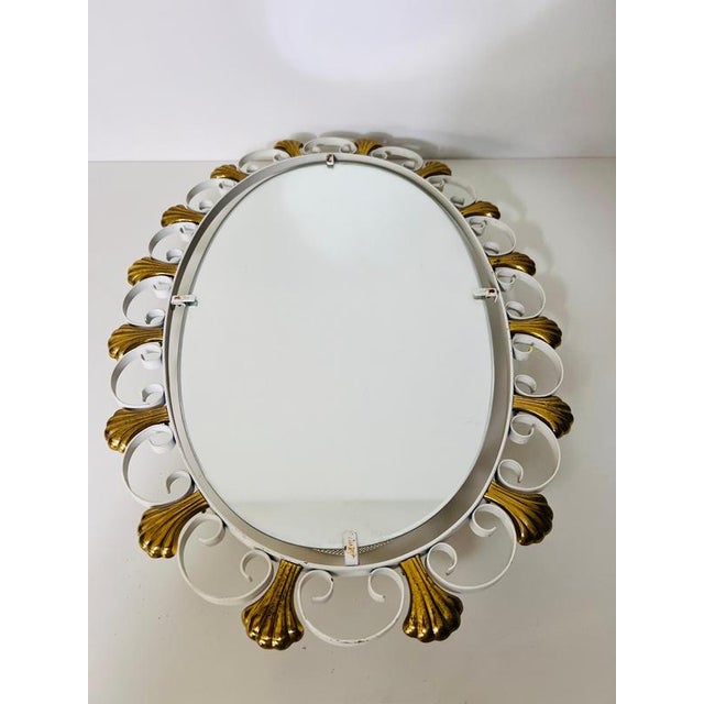 This elegant oval wall mirror, designed by hillebrand in germany during the 1960s, features a perforated brass metal frame...