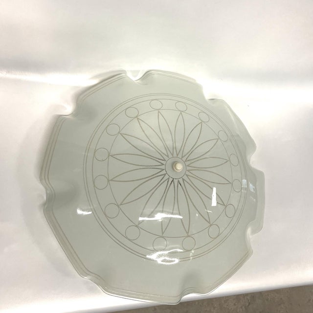 Large 1960s modern sunburst flush mount light featuring a ruffled and striped transparent border with central sunburst and...