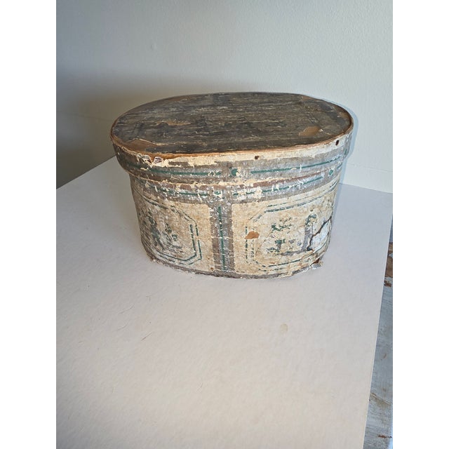 American Wallpaper covered band box with hand cut nails and newspaper interior and original Hannah Davis label. This is in...