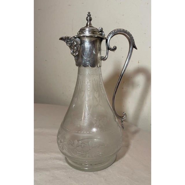 Crafted in the late 19th century Victorian era, this ornate silverplate decanter exudes an air of elegance and...