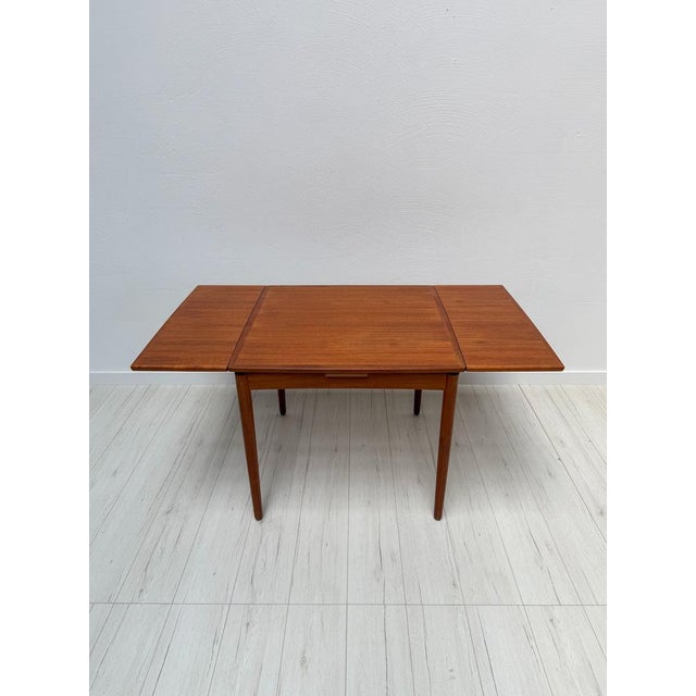 Minimalistic vintage dining table original from the 1960s in teak by poul hundevad. Can be extended on two sides with a...
