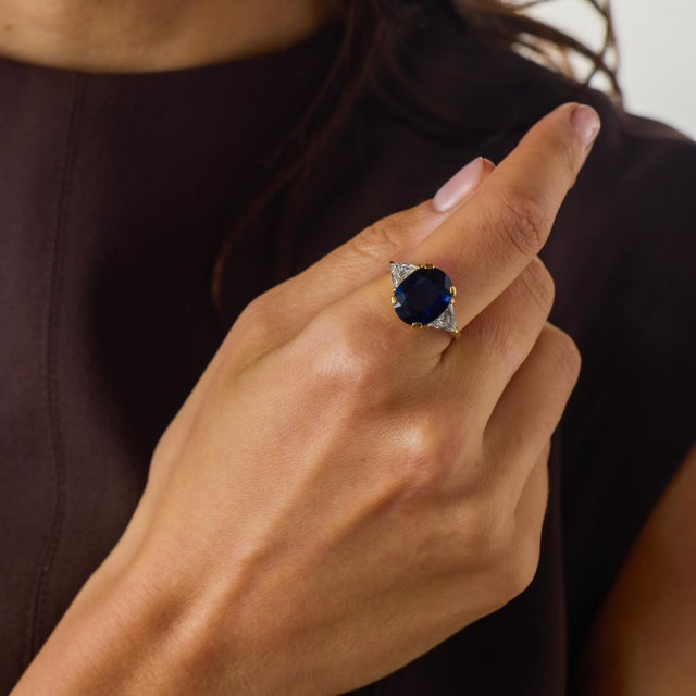 This striking vintage sapphire and diamond ring from the 1970’s is a beautiful jewel centered by an impressive GIA-...