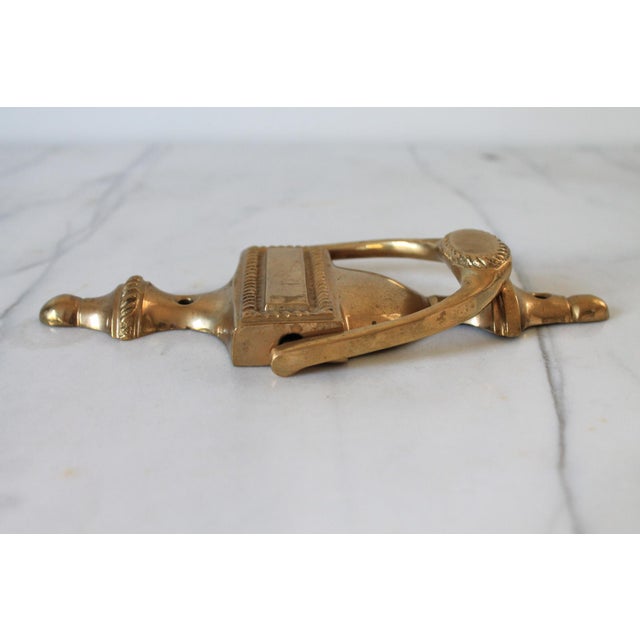 Vintage traditional solid brass urn-style door knocker featuring an integrated nameplate panel and rope-twist detailing....