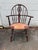 Vintage Windsor-Style Hoop-Back Rush Seat Armchair It features a woven rush seat, a distinctive pierced central splat, and...