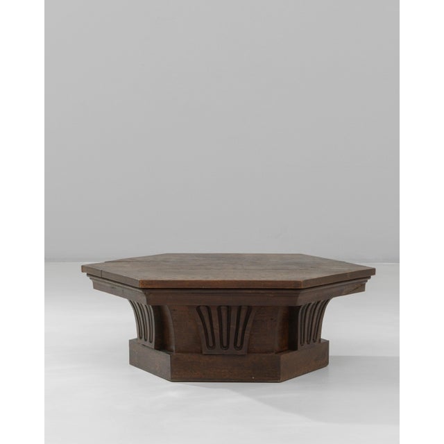 This 1910s French hexagonal oak coffee table presents a striking geometric form paired with finely carved detailing,...