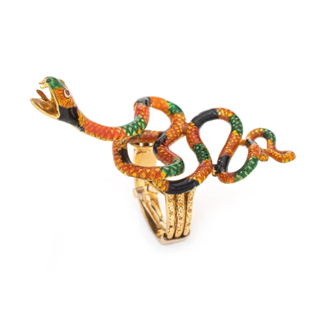 Finely detailed vintage enamel snake ring, crafted in 18 karat yellow gold (circa 1960s to 1970s). Two rubies are set into...