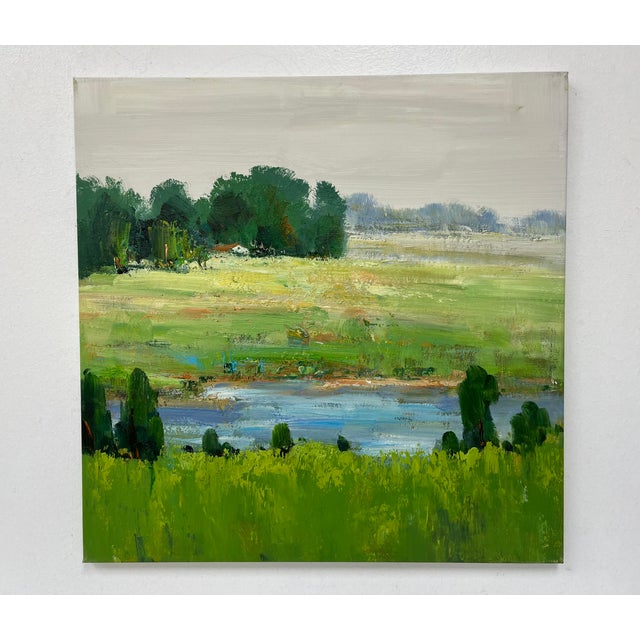 A serene and painterly original oil painting on canvas capturing a quiet view of open meadows and distant trees beside a...