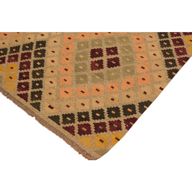 Add a touch of elegance to your home with this casual chic hand woven Tribal Kilim wool rug. Constructed on a loom by...