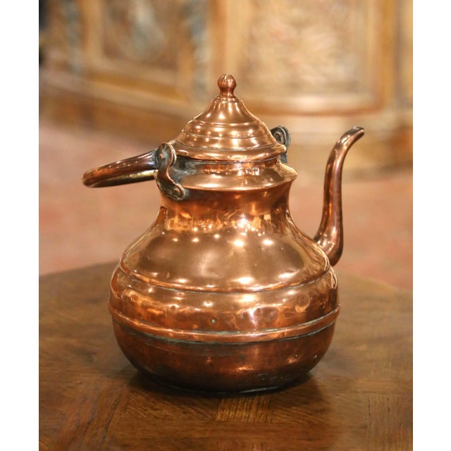 Full of authentic provincial character, this antique copper tea kettle features a beautifully rounded form and warm,...