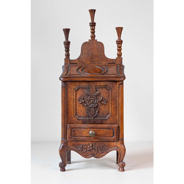 This 19th-century French Louis XV-style walnut farinerio flour box exemplifies the perfect union of form and function....
