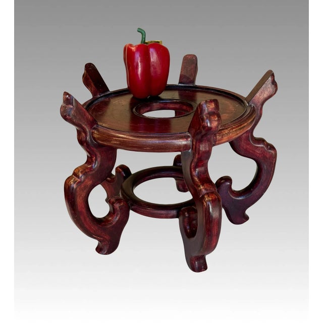 Taller vintage Chinese brown rosewood display stand or pedestal. Circular stand with five stylised dragon shaped legs and...