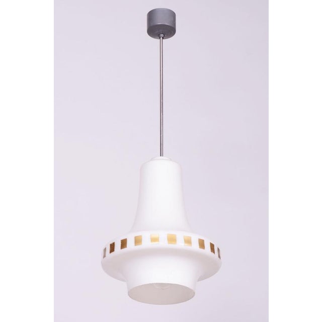 This chandelier is an excellent representative of 1960s Czechoslovak design, following the Mid-Century Modern aesthetic....