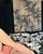 The model is deliciously draped over a black and white botanical print couch, with the print also forming a crown. A...