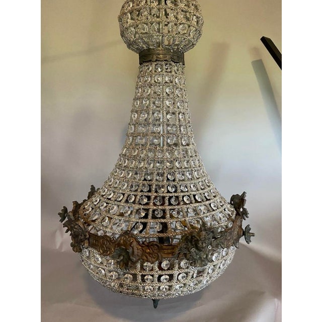 A dramatic vintage French chandelier dating from the 1970s, designed in the Louis XVI Revival style with elegant crystal...