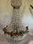 A dramatic vintage French chandelier dating from the 1970s, designed in the Louis XVI Revival style with elegant crystal...