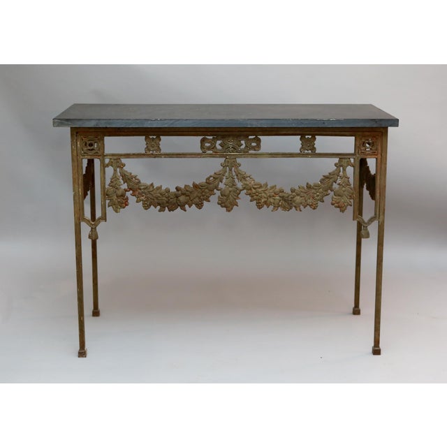 19th century French wrought iron console tables decorated with garlands and swags of floral decoration and original slate...