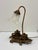 This intricate brass desk lamp featuring two inkwells is likely from the Victorian era. The base in intricately awash with...